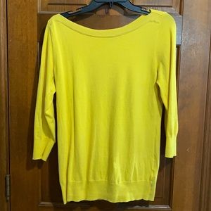 Bright yellow boatneck sweater.
